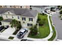 An aerial view of a two-story home, showcasing its driveway, green lawn, and proximity to the neighborhood at 403 Arbor Lakes Dr, Davenport, FL 33896