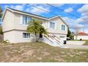 Well-maintained two-story home with a two-car garage, white siding and landscaped front yard at 4151 Nelson Rd, Lake Wales, FL 33898