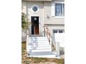 Front entrance with white stairs, wood railings, front door and octagonal window at 4151 Nelson Rd, Lake Wales, FL 33898