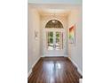 Inviting foyer showcasing hardwood floors, high ceilings, and a modern pendant light at 4224 Clarice Estates Dr, Windermere, FL 34786