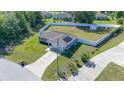 Aerial view of a home with a fenced yard, solar panels and a well-manicured lawn at 10 Pine Track Trl, Ocala, FL 34472