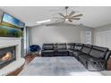 Comfortable living room with a fireplace, sleek leather seating, and hardwood floors at 1063 Fountainhead Dr, Deltona, FL 32725