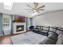 Bright living room with a fireplace, a modern ceiling fan, and comfortable leather seating at 1063 Fountainhead Dr, Deltona, FL 32725