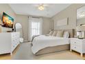 Bright bedroom with a king bed, neutral décor, and large windows for natural light at 1118 Saint Tropez Ct, Kissimmee, FL 34759
