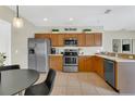 Well-equipped kitchen with stainless steel appliances and wooden cabinets at 1118 Saint Tropez Ct, Kissimmee, FL 34759