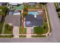 Aerial view of home with solar panels, a large pool, a red property line, and a well-kept yard at 12104 Shallot St, Orlando, FL 32837