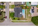 Aerial view of home featuring a large pool, solar panels, and a well-kept yard at 12104 Shallot St, Orlando, FL 32837