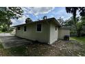 Side view of the home featuring a well-maintained exterior and a spacious driveway at 1602 W 12Th St, Sanford, FL 32771