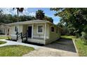 Exterior view of a cozy home with fresh landscaping and a well-maintained lawn at 1602 W 12Th St, Sanford, FL 32771