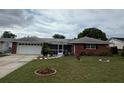 Charming single-story brick home with a well-manicured lawn and a two-car garage at 2013 Marilyn Ave, Winter Haven, FL 33881