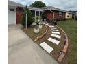 Inviting walkway leading to a screened front porch and a charming brick home at 2013 Marilyn Ave, Winter Haven, FL 33881