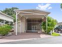 Beautiful covered entrance and outdoor living space with neutral siding and brick paved driveway, creating great curb appeal at 2343 St George Dr, Davenport, FL 33837