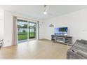 Inviting living room with large sliding glass doors leading to a screened patio and a cozy seating area at 2668 Coachman Dr, Deltona, FL 32738