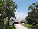 Aerial view of property featuring a charming single-story home, mature trees and an attached two car garage at 2700 Cherokee Rd, St Cloud, FL 34772