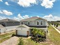 Beautiful two-story home featuring a two-car garage, brick accents, and freshly manicured front yard at 2759 Slash Way, St Cloud, FL 34771