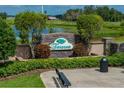 Beautiful Terranova community entrance with stone signage, lush landscaping, and bench seating at 301 Terranova Blvd, Winter Haven, FL 33884