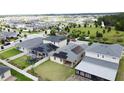 Aerial view of neighborhood homes with solar panels, green lawns, and fenced backyard at 3193 Crispin Cir, Harmony, FL 34773