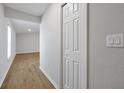 Bright hallway with wood-look flooring and a white door to the side at 328 Lily Ln, Davenport, FL 33837