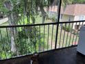 Tranquil view from a balcony overlooking lush landscaping and neighboring buildings at 4085 Dijon Dr # 4085J, Orlando, FL 32808