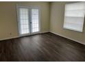 Bright room featuring wood-look flooring and a door with access to a balcony/patio at 4085 Dijon Dr # 4085J, Orlando, FL 32808