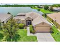 Lovely one-story home near a lake, featuring a well-kept lawn and pleasing landscape design at 4244 Windchime Ln, Lakeland, FL 33811