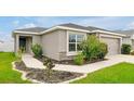 A charming home featuring lush landscaping and a welcoming sidewalk leading to the front door at 4505 Hummingbird Ln, Haines City, FL 33844