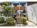 Townhouse with a concrete staircase leading to the entrance, with attractive landscaping at 4570 Tower Pine Rd # Ge, Orlando, FL 32839