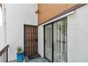 Inviting porch area featuring a secure door, sliding glass door, and welcome mat at 4570 Tower Pine Rd # Ge, Orlando, FL 32839