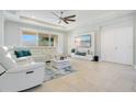 Bright living room with neutral tones, tiled floors, entertainment center, and lots of natural light at 4918 Wildwood Pointe Rd, Winter Garden, FL 34787