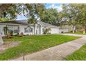Charming single-story home with a manicured lawn, mature trees and an attached two-car garage at 512 Yellow Tail Pl, Chuluota, FL 32766