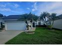 Charming single-story house with a well-kept lawn, two-car garage, and tasteful landscaping at 5661 Parkview Lake Dr, Orlando, FL 32821