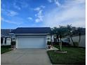 Beautifully maintained single-story home with an attached garage and tropical landscaping at 5661 Parkview Lake Dr, Orlando, FL 32821