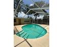 Refreshing screened-in pool, complete with steps and ladder, ideal for relaxing and enjoying sunny days at 760 Bearcreek Dr, Bartow, FL 33830