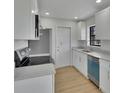 Bright kitchen with white cabinets, stainless steel appliances, and granite countertops at 925 Roswell Ter, Deltona, FL 32738