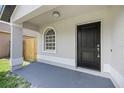 A cozy porch with black door welcomes you to your new home at 946 Little Creek Rd, Orlando, FL 32825
