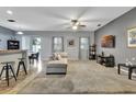 Spacious living room with plush carpeting, fan, and plenty of natural light and bar seating at 954 Revere Ave, Haines City, FL 33844