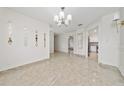 Spacious dining area with decorative chandelier and tile floors at 112 Rosewood Ct, Kissimmee, FL 34743