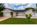 Charming single-story home with well-manicured lawn and neutral-colored exterior at 112 Rosewood Ct, Kissimmee, FL 34743