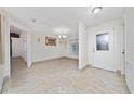 Elegant foyer with a decorative glass front door, chandelier, and tile flooring at 112 Rosewood Ct, Kissimmee, FL 34743