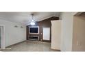 Living room featuring high ceilings, a fan, and modern fireplace at 112 Rosewood Ct, Kissimmee, FL 34743