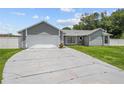 Charming one story home featuring a two-car garage, mature landscaping, and a long driveway at 113 Candlewood Ct, Kissimmee, FL 34743