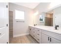 Modern bathroom with double vanity, sleek fixtures, and neutral tile at 14967 Sw 43Rd St, Ocala, FL 34473