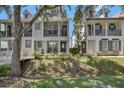 Inviting townhome with a cozy front porch and lush landscaping at 1607 Wilson Ave, Orlando, FL 32804