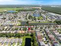 Expansive aerial view showcasing the neighborhood with multiple ponds and lush greenery, highlighting a home with a pool at 195 Hideaway Beach Ln, Kissimmee, FL 34746