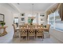 Bright dining room featuring a chandelier, neutral colors, and built-in shelving for displaying decorations at 195 Hideaway Beach Ln, Kissimmee, FL 34746