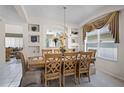 Elegant dining room with a decorative chandelier, built-in display shelves, and a large window for natural light at 195 Hideaway Beach Ln, Kissimmee, FL 34746