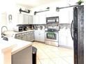 Modern kitchen with stainless steel appliances, tiled backsplash, and ample counter space at 2024 Bearing Ln, Kissimmee, FL 34744
