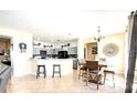 Open concept living room and kitchen with tile flooring, gray cabinets, and updated appliances at 2024 Bearing Ln, Kissimmee, FL 34744