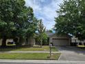 Inviting single-Gathering home with mature trees, a well-manicured lawn, and a two-car garage, offering great curb appeal at 2141 Fawn Meadow Cir, St Cloud, FL 34772