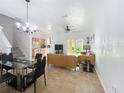 Open-concept living and dining area featuring tile floors and neutral decor at 226 Verona Ave, Davenport, FL 33897